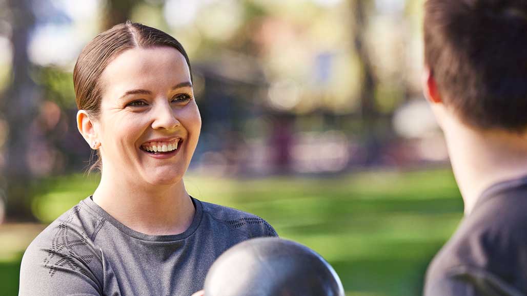 Amanda and brother outside with gym equipment CarerGateway SM